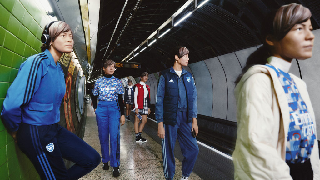 Models on a Tube platform wearing Arsenal collection kit