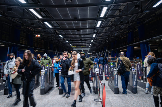 Customers passing through ticket gates Tube station
